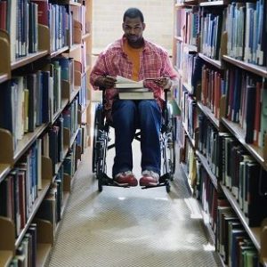 picture of student who uses wheelchair in the library