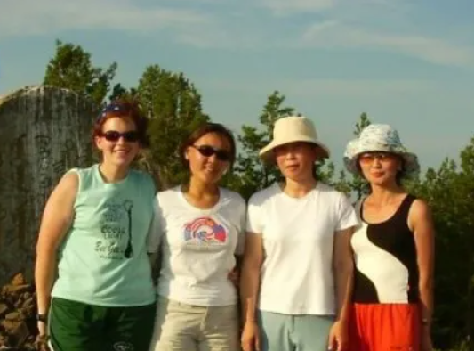 two women wearing sunglasses two wearing hats smiling