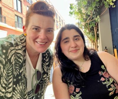 Annie Tulkin on the left wearing a green and white tropical shirt. Luna Fera on the right wearing a black tank top. Both women are smiling.