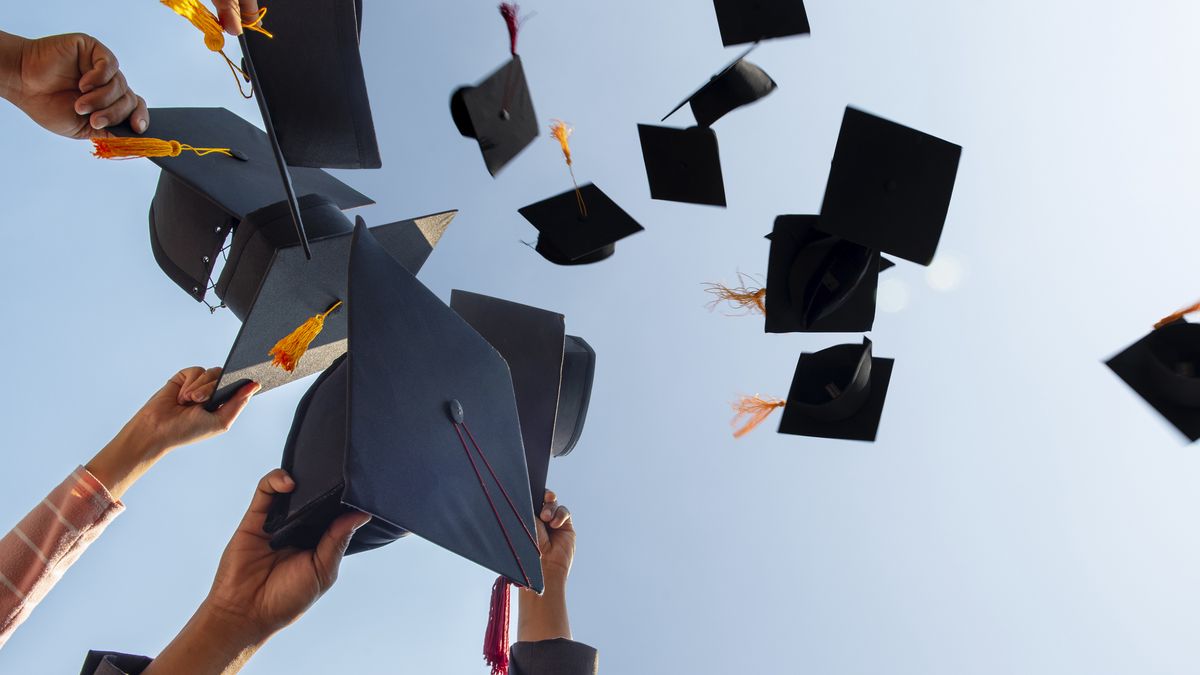 graduation caps flying in the air