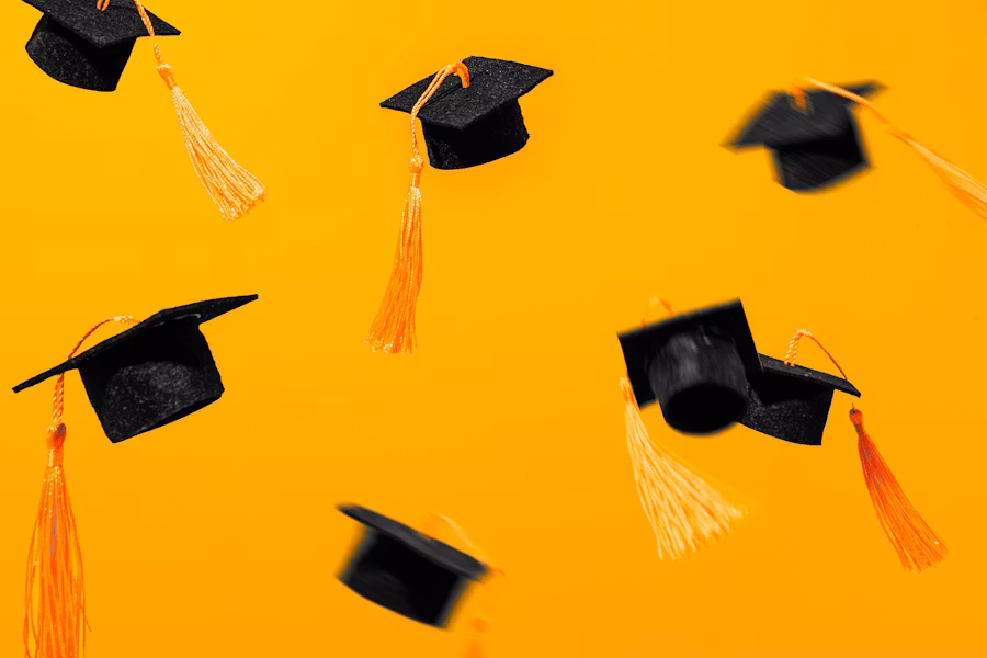 Yellow background and graduation hats flying in the air